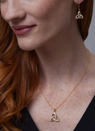 Close up of Red haired model wearing 14ct Gold Vermeil Trinity Knot Pendant with Cubic Zirconia with matching earrings